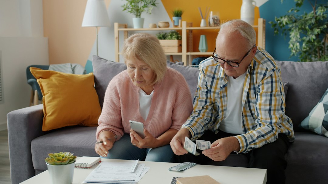 Older couple reviewing household bills, an illustrative image for reporting on Social Security benefits and retirement budgets.